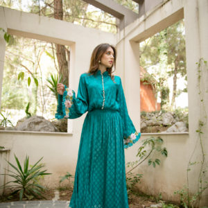 Silk textured long Aline with gathers. Embroidered patch at sleeves adorned  with pearls and trimming detailing.